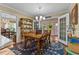 Charming dining room with hardwood floors, chandelier, and view to the outdoors at 3417 Windmere Dr, Sanford, NC 27330