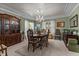 Elegant dining room with decorative chandelier, wood furniture and neutral carpet at 3417 Windmere Dr, Sanford, NC 27330