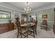 Comfortable dining room area with neutral carpet, chandelier, and views to other rooms at 3417 Windmere Dr, Sanford, NC 27330