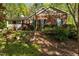Well-maintained brick home with covered porch and landscaped front yard at 3417 Windmere Dr, Sanford, NC 27330