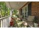 Inviting covered front porch, with comfortable seating and a ceiling fan at 3417 Windmere Dr, Sanford, NC 27330