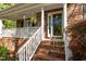 Charming brick front porch with white railing and stately columns at 3417 Windmere Dr, Sanford, NC 27330