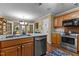 Functional kitchen with stainless appliances, light cabinets, and view to breakfast area at 3417 Windmere Dr, Sanford, NC 27330