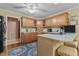 Well-lit kitchen with light wood cabinets, blue countertops and a patterned rug at 3417 Windmere Dr, Sanford, NC 27330