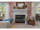 Cozy living room featuring a fireplace, mantel decor, and neutral-toned walls and flooring at 3417 Windmere Dr, Sanford, NC 27330