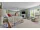 Bright main bedroom featuring a fireplace, accent chair, and neutral carpet at 3417 Windmere Dr, Sanford, NC 27330
