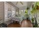 Bright sunroom filled with natural light, potted plants, and a cozy daybed at 3417 Windmere Dr, Sanford, NC 27330