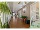 Long sunroom with wood floors, lots of windows, and many houseplants at 3417 Windmere Dr, Sanford, NC 27330