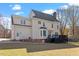 Spacious backyard view of a two-story home featuring a deck, and landscaped lawn at 3908 Yateswood Ct, Raleigh, NC 27603