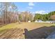 Spacious backyard featuring mature trees, play area, and a storage shed at 3908 Yateswood Ct, Raleigh, NC 27603