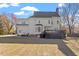 Backyard view of a large, two-story home featuring a deck, and landscaped yard at 3908 Yateswood Ct, Raleigh, NC 27603