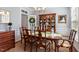 Well-lit dining room includes a hutch, modern chandelier, and access to the kitchen at 3908 Yateswood Ct, Raleigh, NC 27603