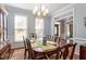 Inviting dining room features hardwood floors, natural light, and decorative light fixture at 3908 Yateswood Ct, Raleigh, NC 27603