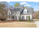 Charming two-story home with a welcoming front porch and mature trees at 3908 Yateswood Ct, Raleigh, NC 27603