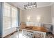 Bright office featuring a decorative rug, modern light fixture and a wooden desk at 3908 Yateswood Ct, Raleigh, NC 27603