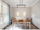 Bright office featuring a decorative rug, modern light fixture and a wooden desk at 3908 Yateswood Ct, Raleigh, NC 27603