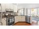 Open kitchen features stainless steel appliances, tiled backsplash, and a breakfast nook at 3908 Yateswood Ct, Raleigh, NC 27603