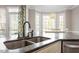 Close-up view of the kitchen sink area that features a double sink, stone countertops and breakfast nook at 3908 Yateswood Ct, Raleigh, NC 27603