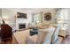 Cozy living room with a fireplace, plush seating, and ample natural light at 3908 Yateswood Ct, Raleigh, NC 27603