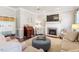 Cozy living room with a fireplace, plush seating, and ample natural light at 3908 Yateswood Ct, Raleigh, NC 27603