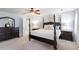 Spacious main bedroom boasts a four-poster bed, ceiling fan, and and night stands at 3908 Yateswood Ct, Raleigh, NC 27603