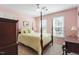 Main bedroom featuring wooden bed frame, carpeted floors, and two windows at 3908 Yateswood Ct, Raleigh, NC 27603