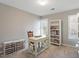 This office features a desk, chair, shelving, and natural light from two windows at 3908 Yateswood Ct, Raleigh, NC 27603