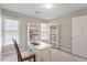 Bright office space featuring white desk, built-in shelves and natural light from two windows at 3908 Yateswood Ct, Raleigh, NC 27603