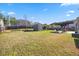Large fenced backyard with mature lawn, shed, garden beds, and patio furniture at 405 Club Center Dr, Youngsville, NC 27596