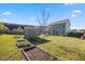 Spacious backyard with a garden shed and multiple raised garden beds at 405 Club Center Dr, Youngsville, NC 27596