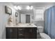 Bathroom featuring a double sink vanity, framed mirror, and a shower with a blue curtain at 405 Club Center Dr, Youngsville, NC 27596