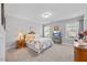 Bright bedroom featuring neutral walls, carpet, and a large window for natural light at 405 Club Center Dr, Youngsville, NC 27596