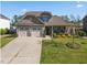 Charming two-story home featuring a well-maintained lawn, a two-car garage, and tasteful landscaping at 405 Club Center Dr, Youngsville, NC 27596