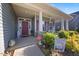 Inviting front porch with decorative columns and a well-maintained garden at 405 Club Center Dr, Youngsville, NC 27596