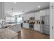 Bright, modern kitchen featuring stainless steel appliances, granite countertops, and hardwood floors at 405 Club Center Dr, Youngsville, NC 27596