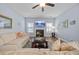 Cozy living room with fireplace, large windows, and comfortable seating, perfect for relaxation at 405 Club Center Dr, Youngsville, NC 27596