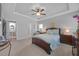 Serene main bedroom featuring a trey ceiling, ceiling fan, and an en-suite bathroom at 405 Club Center Dr, Youngsville, NC 27596