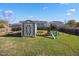 A storage shed and backyard playset for in a spacious backyard at 405 Club Center Dr, Youngsville, NC 27596