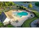 Overhead perspective of a community pool area with lounge chairs, playground, and manicured landscaping at 425 Summit Trail Dr, Hillsborough, NC 27278