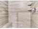 Close-up of tiled shower stall with bench, shelving, and modern fixtures at 425 Summit Trail Dr, Hillsborough, NC 27278