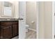 Powder room features tile floors, wooden vanity with granite counters, and a toilet at 425 Summit Trail Dr, Hillsborough, NC 27278