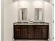 Bathroom vanity area features double sinks and a large framed mirror at 425 Summit Trail Dr, Hillsborough, NC 27278