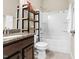 Bathroom includes a tub-shower combo, vanity, and open shelving at 425 Summit Trail Dr, Hillsborough, NC 27278