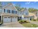Beautiful townhome featuring stone accents, two-car garage, and well-manicured landscaping at 425 Summit Trail Dr, Hillsborough, NC 27278