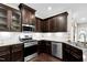 Eat-in kitchen featuring stainless steel appliances and bright white subway tile backsplash at 425 Summit Trail Dr, Hillsborough, NC 27278