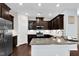 Modern kitchen featuring dark cabinets, stainless steel appliances, and white subway tile backsplash at 425 Summit Trail Dr, Hillsborough, NC 27278