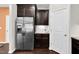 Modern kitchen featuring stainless steel refrigerator and dark wood cabinets with granite countertops at 425 Summit Trail Dr, Hillsborough, NC 27278