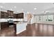 Stylish kitchen with dark wood cabinetry, stainless steel appliances, and a center island with bar seating at 425 Summit Trail Dr, Hillsborough, NC 27278