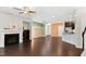 Spacious living room showcasing a fireplace, dark wood floors, and open kitchen at 425 Summit Trail Dr, Hillsborough, NC 27278