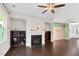 Inviting living room featuring a cozy fireplace and built-in shelving for storage and display at 425 Summit Trail Dr, Hillsborough, NC 27278